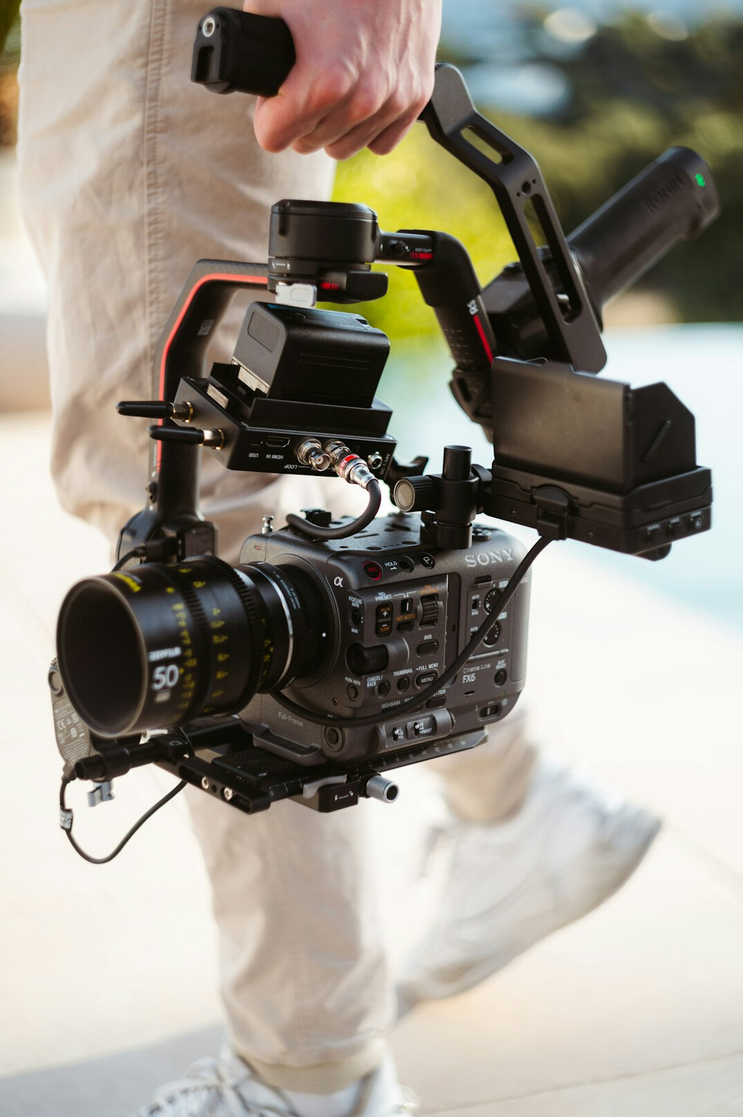 Camera operator filming a scene with professional video equipment
