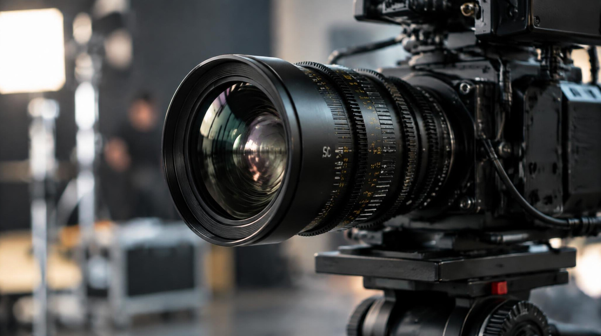 Close-up of a professional cinema camera lens on set