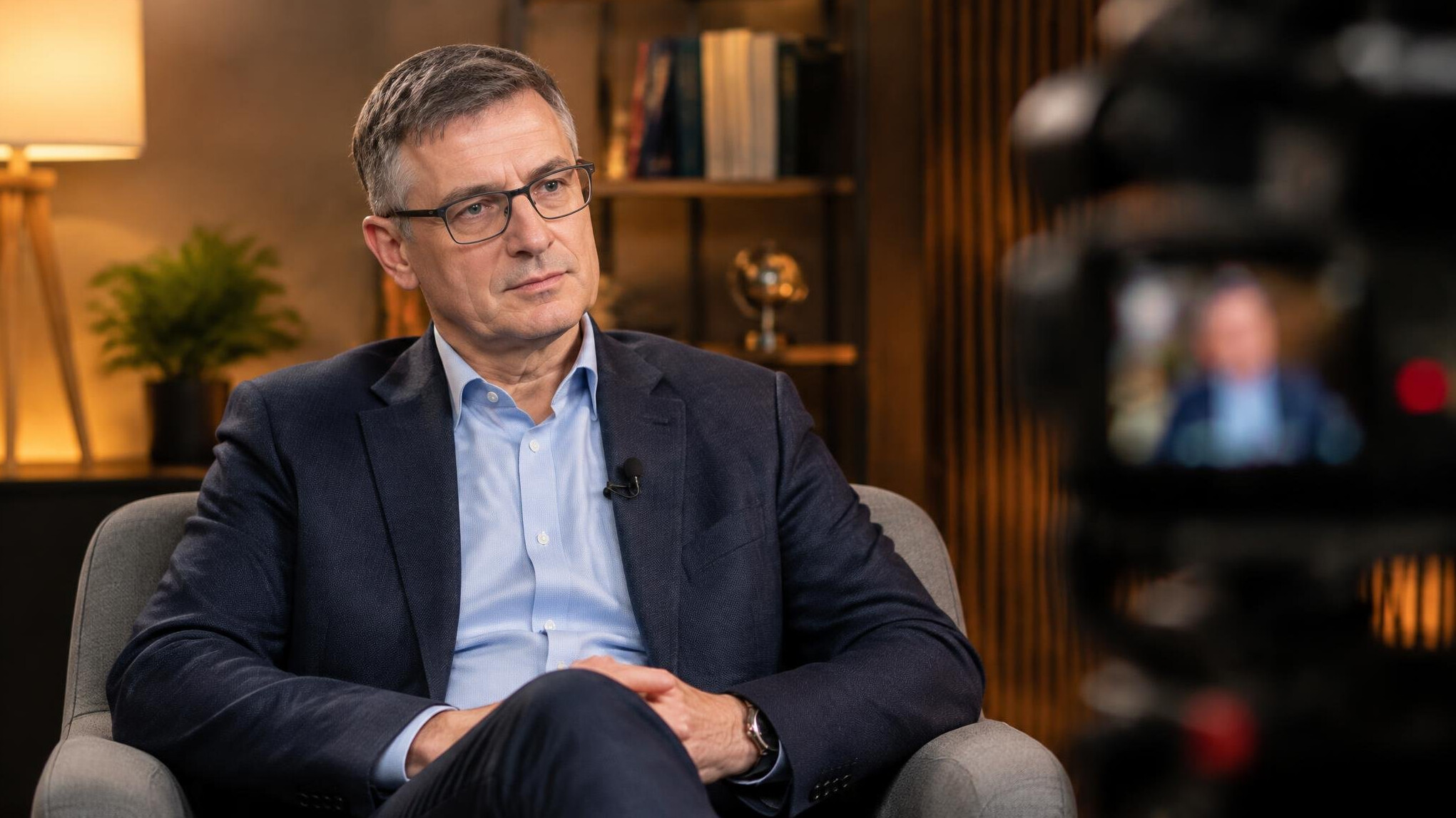Expert being interviewed in a studio with a camera and microphone